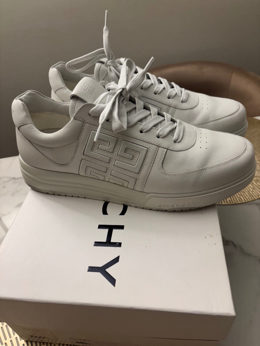 Mens White Givenchy G4 sneakers , featuring an embossed 4G logo on the side.